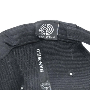 Detail of the internal seams and HAN WILD woven label inside the black tactical cap