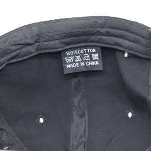 Detail view of the inner black cotton lining with care labels and material tags