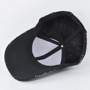 Detail view of baseball cap interior showing black sweatband and gold metallic thread