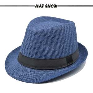Detailed view of blue woven straw jazz hat with classic black grosgrain ribbon band