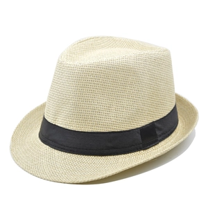 Detailed close-up of woven paper straw fedora hat with a wide black ribbon band