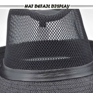 Detail view of black mesh crown and leather belt decoration on the vintage straw hat