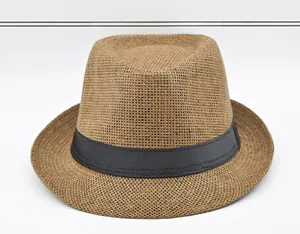 Detailed close-up of brown woven straw fedora hat with a classic black ribbon band