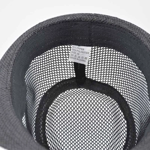 Detail view of internal straw hat structure with washing label and size 58 tag