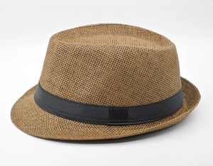 Close-up of a brown woven straw fedora hat featuring a classic black decorative ribbon band