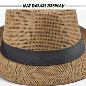Close-up of the fine woven texture and black ribbon band on a classic straw fedora hat