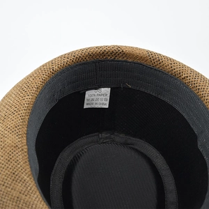 Close-up of internal sweatband and 100% paper material label on a classic straw fedora hat
