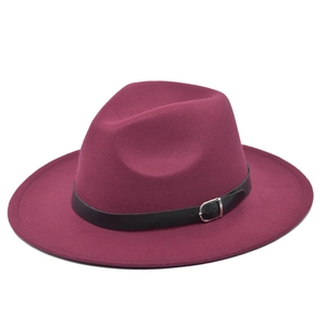 Detailed view of burgundy fedora hat with smooth wool felt texture and black belt strap buckle