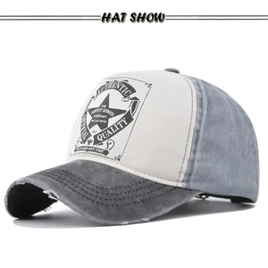 Close-up of vintage washed baseball cap featuring distressed brim and star graphic print