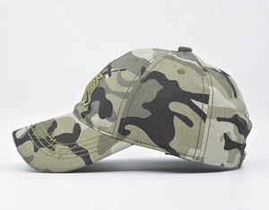 Detailed view of woodland camouflage baseball cap with stitching on the curved brim