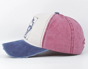 Detail of vintage washed baseball cap showing contrast colors and distressed brim finish