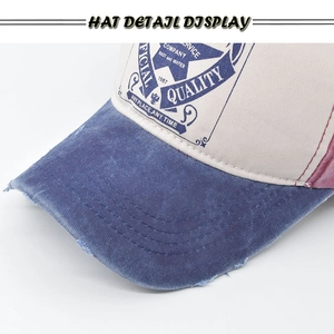 Detailed macro view of vintage washed canvas baseball cap with worn brim and 1967 print