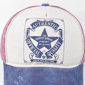 Washed vintage baseball cap with multi-color contrast panels and distressed badge print