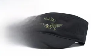 Detail of military patrol cap featuring embroidered US NAVAL text and golden shield crest