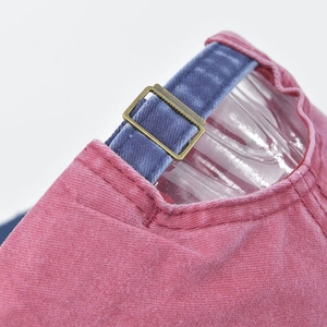 Detail of washed cotton baseball cap with blue velvet strap and bronze buckle
