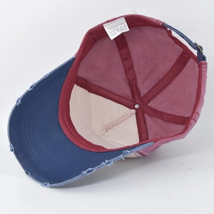 Detail view of cotton baseball cap interior showing 100 percent cotton label and stitching
