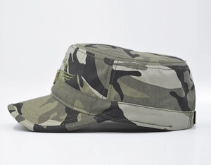 Detailed close-up of tactical woodland camouflage cadet cap with eagle wing embroidery