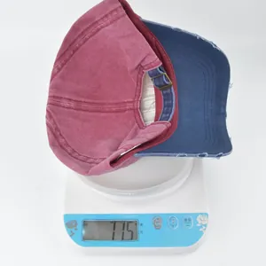 Detailed top view of vintage washed cotton baseball caps weighing 77.5g on a digital scale