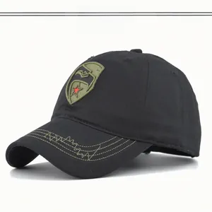 Close-up of black baseball cap featuring a shield star embroidery and green contrast stitching