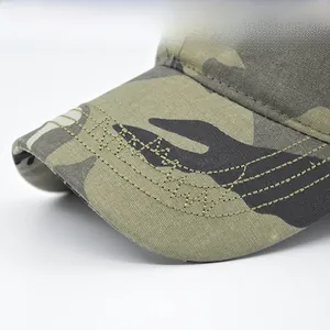 Detailed close-up showing reinforced stitching on a camouflage canvas baseball cap brim