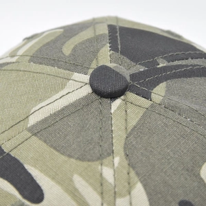 Close-up of camouflage baseball cap crown featuring fine stitching and top button detail