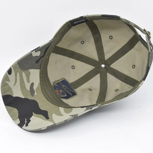 Detail view of camouflage baseball cap interior with 100% cotton label and metal buckle