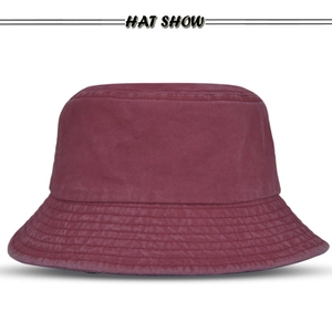 Close-up of wine red washed cotton bucket hat with reinforced stitching on the brim