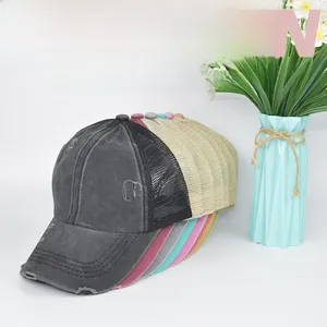 Detail showing various colors of washed criss-cross ponytail caps with breathable mesh layer