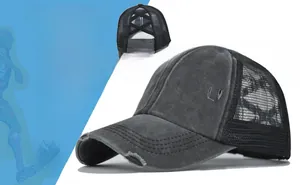 Detailed close-up of dark grey washed denim mesh baseball cap with criss cross elastic back