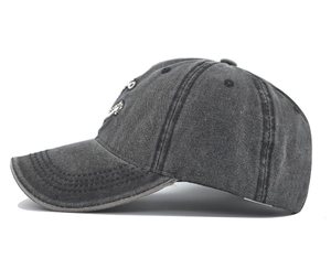 Close-up of vintage washed denim baseball cap featuring embroidery and distressed texture