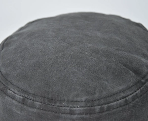 Close-up of dark grey washed cotton bucket hat with detailed stitching and vintage texture
