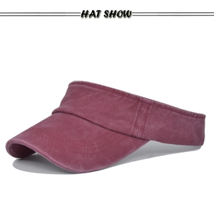 Close-up of wine red washed cotton sun visor with curved brim and reinforced stitching