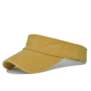 Detailed view of ginger yellow washed cotton visor with refined stitching on brim