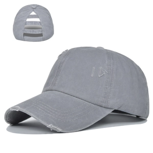 Detail view of washed grey cotton ponytail baseball cap with distressed edge and back openings