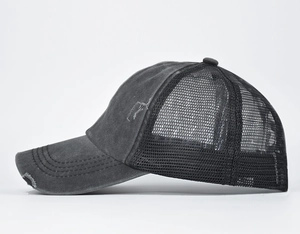 Close-up of distressed grey ponytail baseball cap with breathable mesh and ripped brim detail