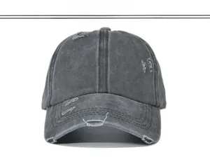 Front view of vintage washed ponytail baseball cap with distressed hole details