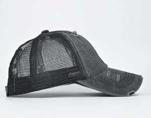 Detail of distressed washed mesh trucker hat showing side view and frayed brim