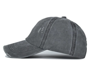 Detail view of washed cotton baseball cap with vintage distressed edges and white side embroidery