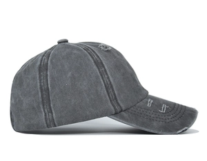 Close-up of vintage washed ponytail baseball cap featuring distressed holes and frayed edges