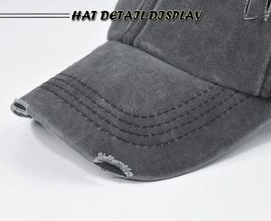 Detail display of distressed dark grey baseball cap showing frayed edge and stitching