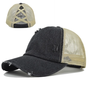 Detail of cross elastic bands on washed denim trucker hat for high ponytails