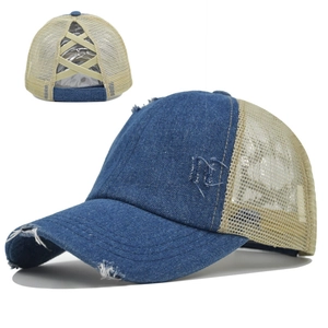 Detail of blue denim distressed ponytail cap with criss-cross elastic bands and mesh back