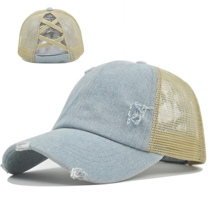 Detail view of light blue denim ponytail cap showing criss-cross elastic mesh and distressed fabric
