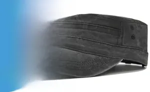 Detail of washed black flat top army cap showing metal eyelets and textured cotton fabric