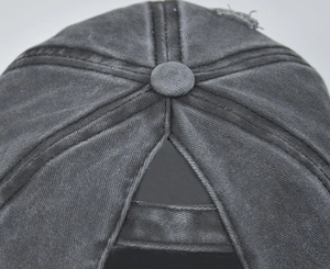 Macro view showing washed distressed cotton texture and ponytail opening on baseball cap
