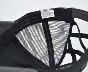 Detail of cross elastic ponytail hat showing 65% cotton mesh and interior stitching