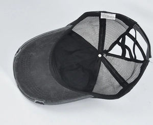 Detailed view of gray distressed ponytail cap interior with mesh and 65% cotton label