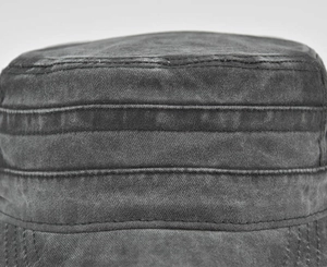 Detailed close-up of dark grey washed cotton fabric with visible horizontal stitching lines