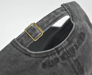 Detail of adjustable metal buckle and New York City embroidery on washed cotton cap