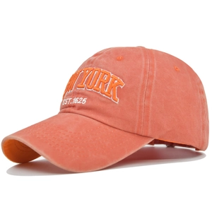Close-up of NEW YORK embroidery on washed cotton coral baseball cap with 1625 text
